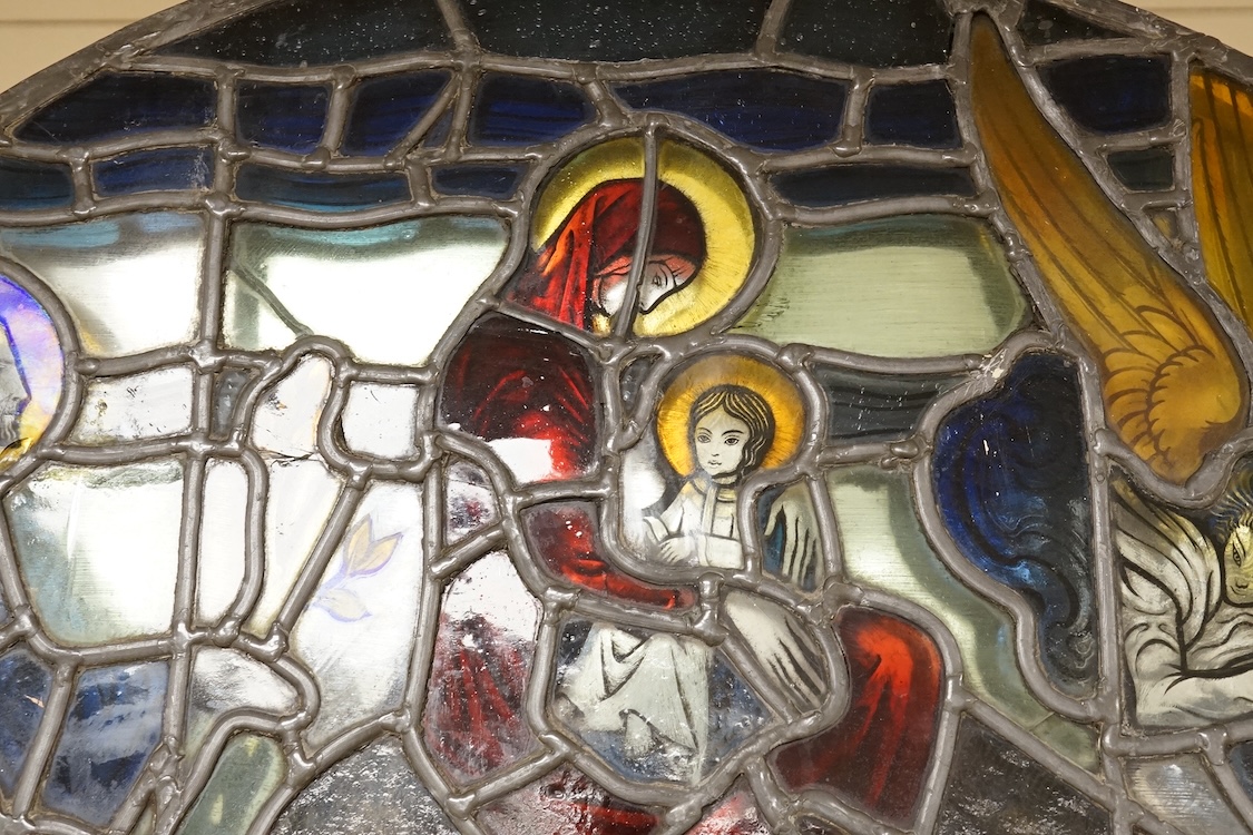 A 20th century semi circular stained glass panel, approximately 80cm wide